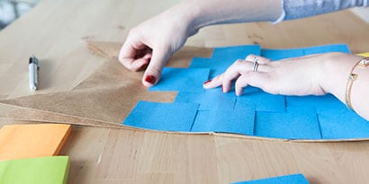 Start layering Post-it® Notes to cover your piñata