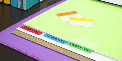 Close-up of office reference guide with color-coded Post-it® Tabs.